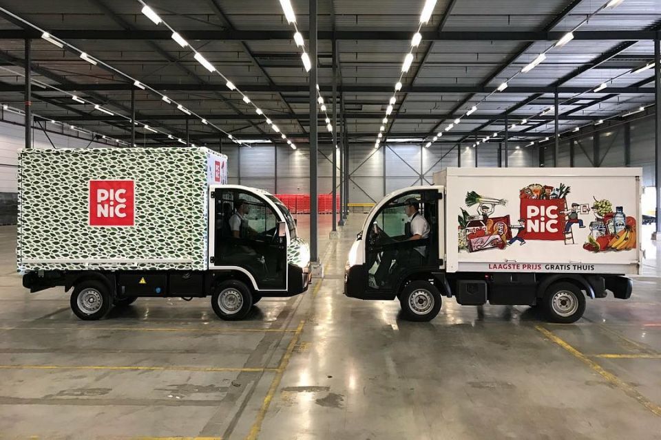 Twee elektrische Picnic-bezorgwagens in een hal